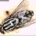 House fly resting on a surface, showing the four dark thoracic stripes and red compound eyes typical of Musca domestica